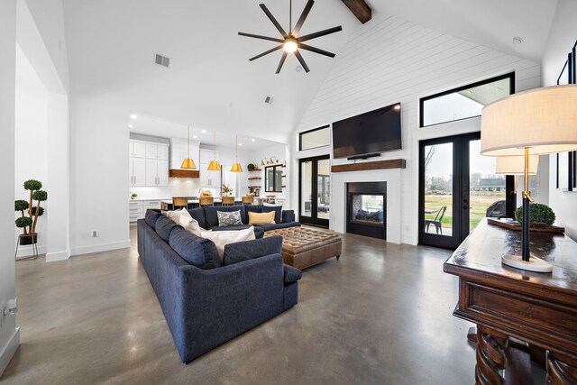 4103 Lea Ln, Fulshear, TX 77406 - living area with high vaulted ceiling, finished concrete flooring, ceiling fan, beam ceiling, and french doors