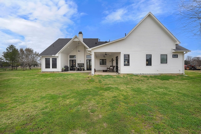 4103 Lea Ln, Fulshear, TX 77406 - back of property with ceiling fan, a chimney, a lawn, and a patio area