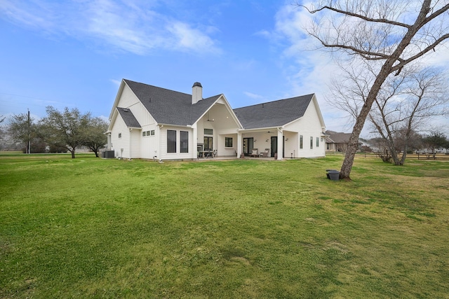 4103 Lea Ln, Fulshear, TX 77406 - back of property featuring a chimney, a patio area, a yard, and a shingled roof