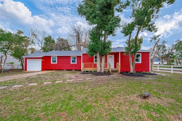 ranch-style home with a front yard and a garage