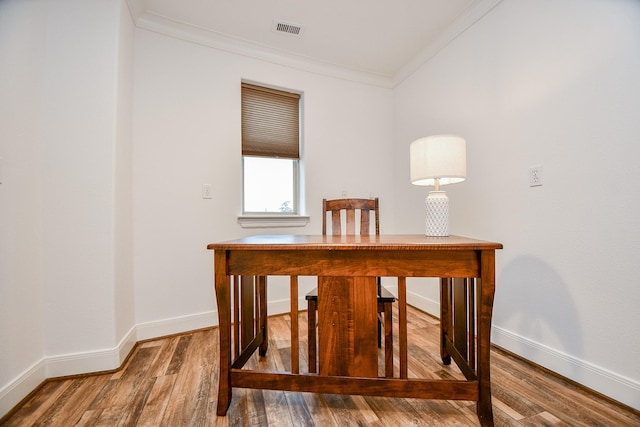 interior space with hardwood / wood-style floors and ornamental molding