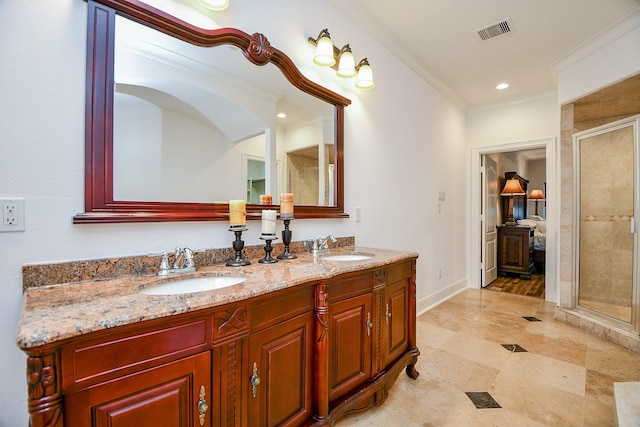 bathroom featuring vanity, crown molding, and a shower with shower door