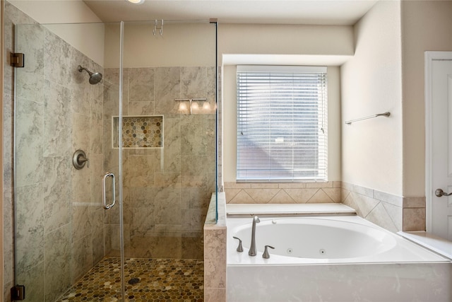 bathroom featuring shower with separate bathtub