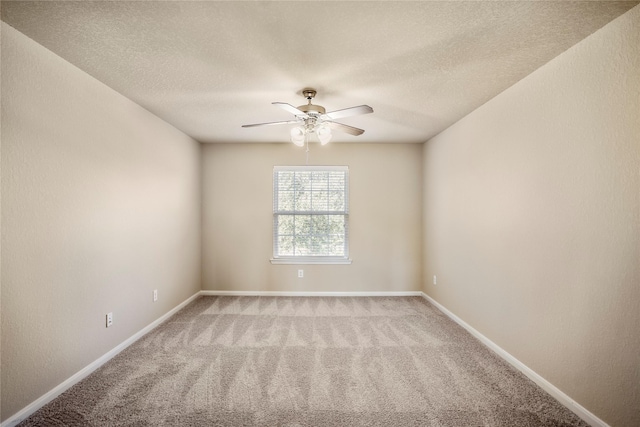 spare room with a textured ceiling, ceiling fan, and light carpet