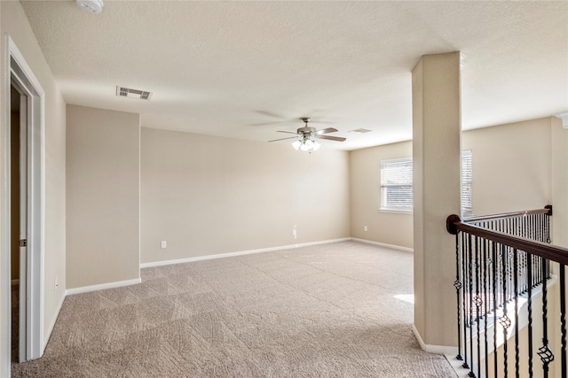 unfurnished room with ceiling fan and light colored carpet