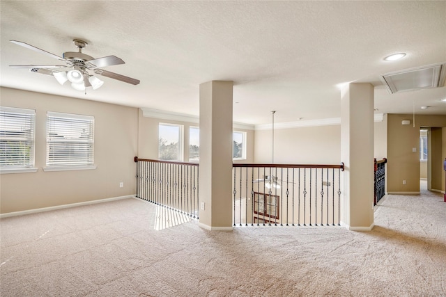 unfurnished room with ceiling fan, ornamental molding, and light carpet