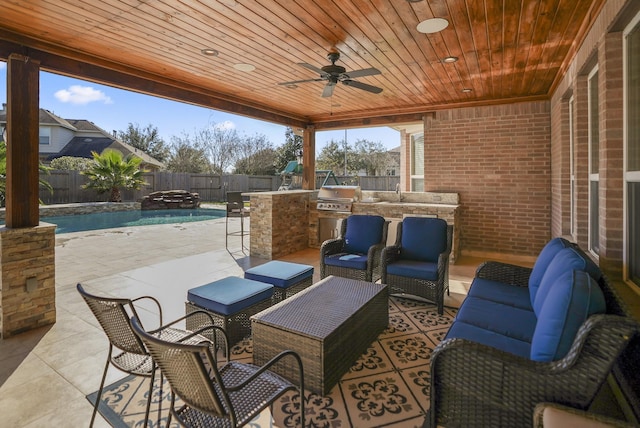 view of patio / terrace featuring an outdoor kitchen, an outdoor wet bar, outdoor lounge area, a grill, and a fenced in pool