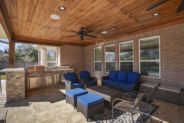 view of patio / terrace featuring sink, ceiling fan, an outdoor living space, and area for grilling