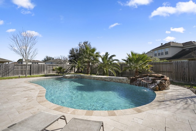 view of swimming pool featuring pool water feature and a patio area