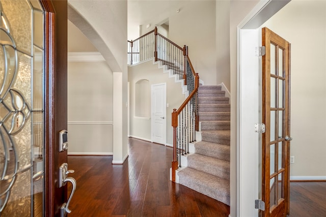 entryway featuring dark wood-type flooring, french doors, and crown molding