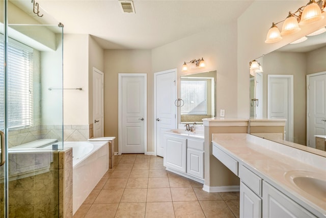 bathroom with vanity, tile patterned floors, independent shower and bath, and plenty of natural light