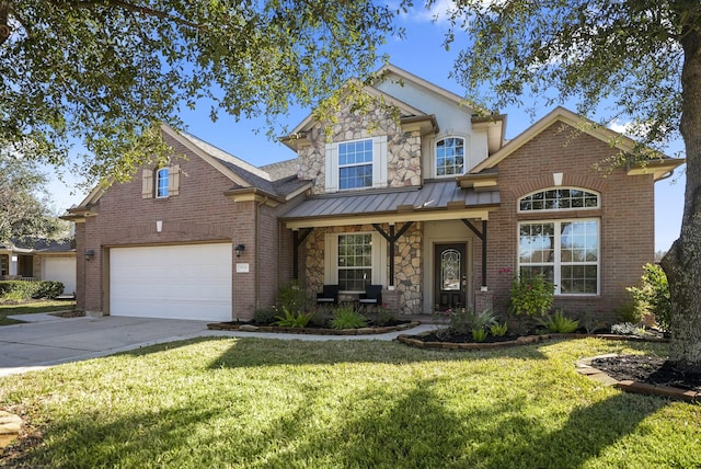 view of front of home featuring a front yard, a garage, and covered porch