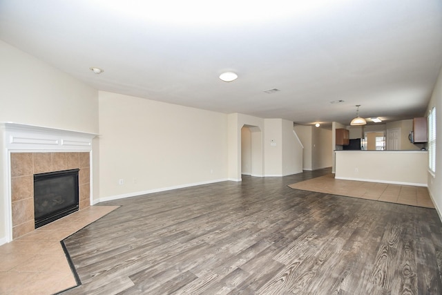 unfurnished living room with a fireplace and wood-type flooring