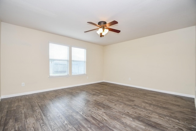 empty room with dark hardwood / wood-style floors and ceiling fan