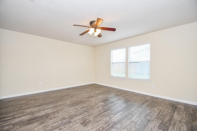 spare room with ceiling fan and dark wood-type flooring