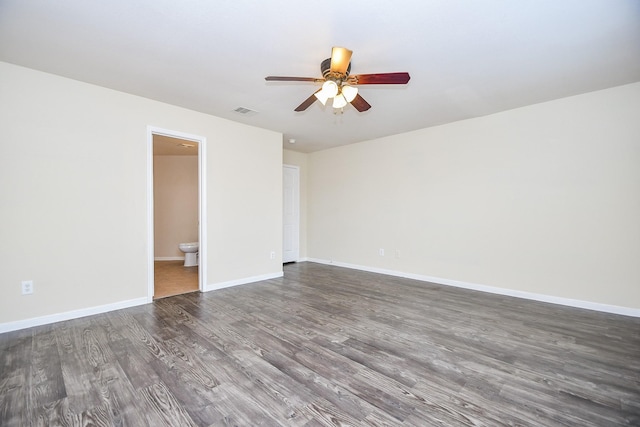 spare room with ceiling fan and dark wood-type flooring