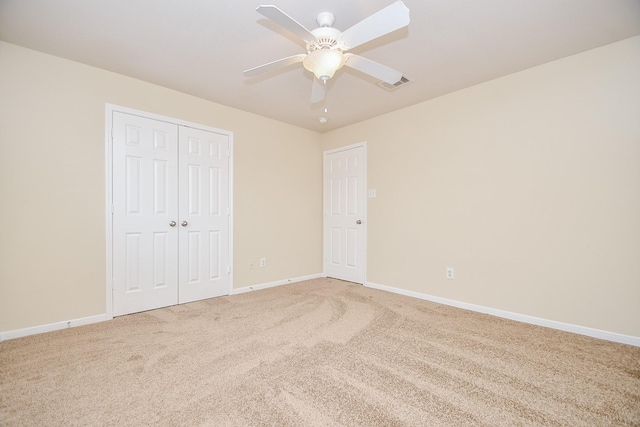 unfurnished bedroom with carpet flooring, ceiling fan, and a closet