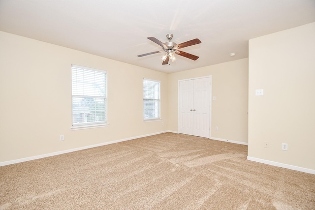 empty room featuring carpet flooring and ceiling fan