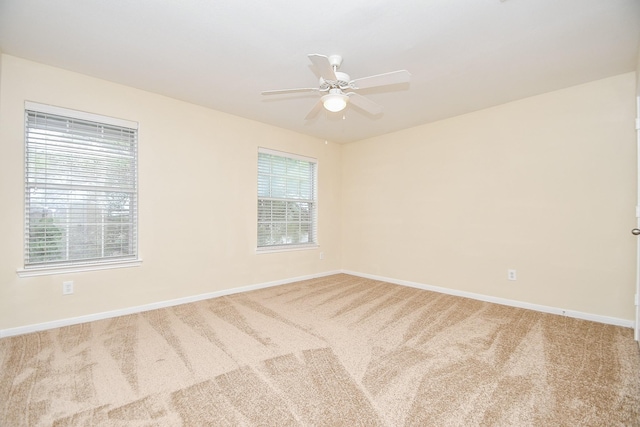 unfurnished room with carpet flooring and ceiling fan