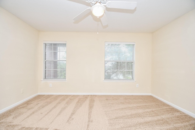 spare room with carpet floors and ceiling fan