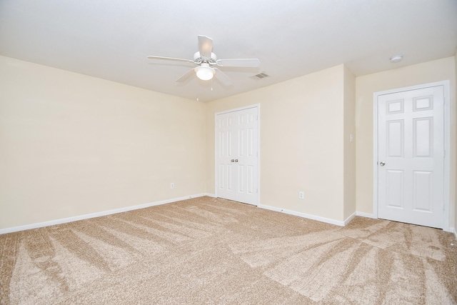 carpeted spare room with ceiling fan