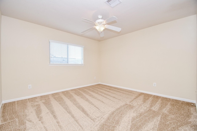 carpeted empty room featuring ceiling fan