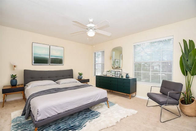 bedroom with ceiling fan and light colored carpet