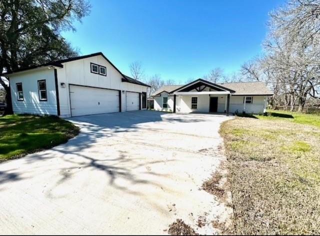 view of front of house with a front yard and a garage