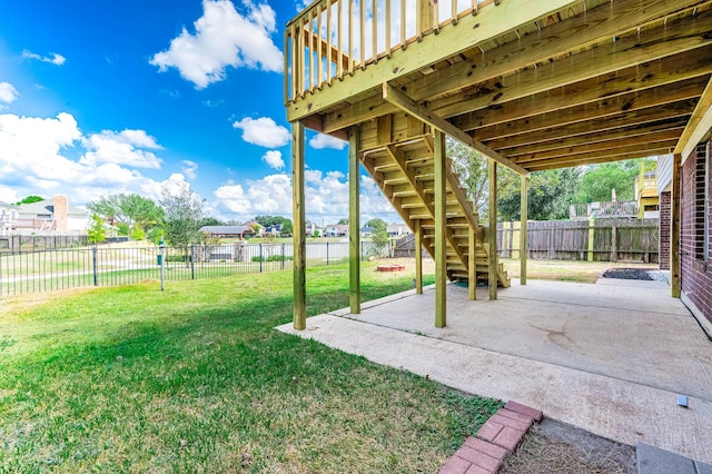 view of yard featuring a deck and a patio