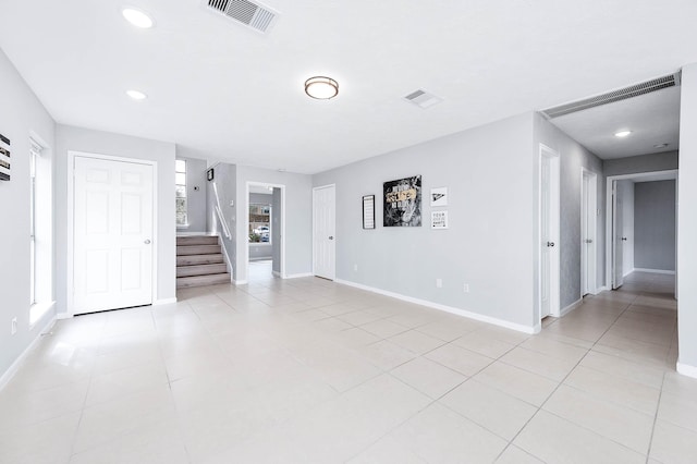 unfurnished living room with a wealth of natural light and light tile patterned floors