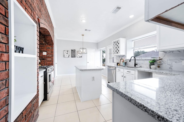 kitchen featuring sink, a kitchen island, pendant lighting, white cabinets, and appliances with stainless steel finishes