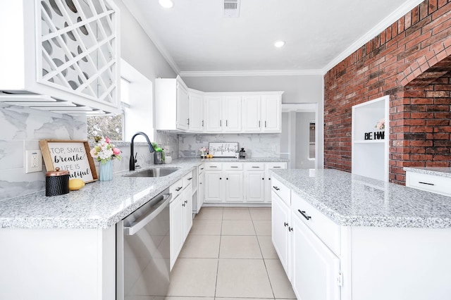 kitchen featuring dishwasher, backsplash, white cabinets, sink, and light stone countertops