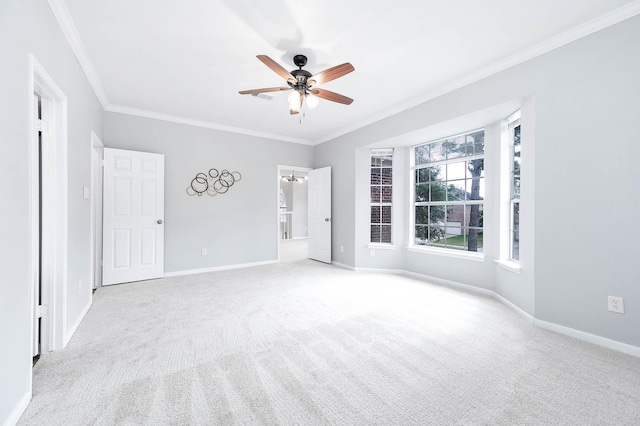 unfurnished room with light colored carpet, ceiling fan, and crown molding