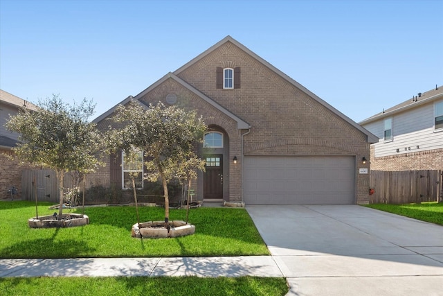 view of front of house featuring a front yard and a garage