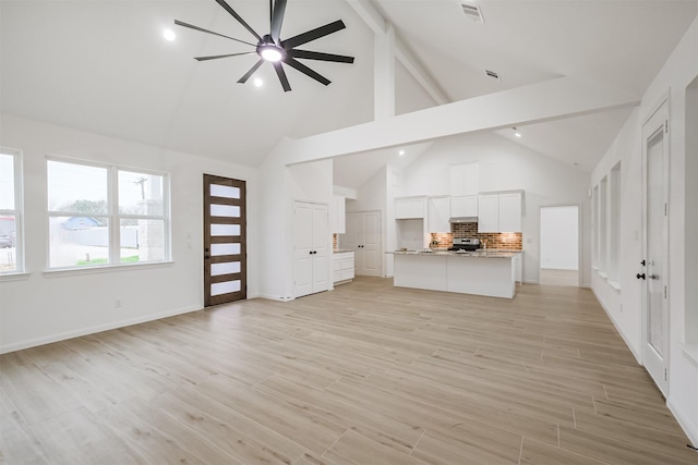 unfurnished living room with beamed ceiling, light hardwood / wood-style floors, high vaulted ceiling, and ceiling fan