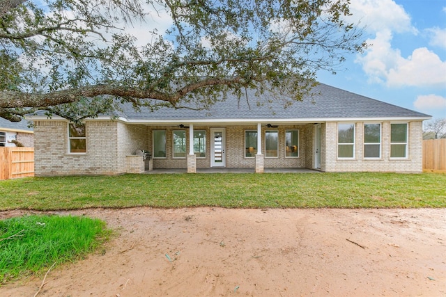 single story home with a patio area and a front lawn