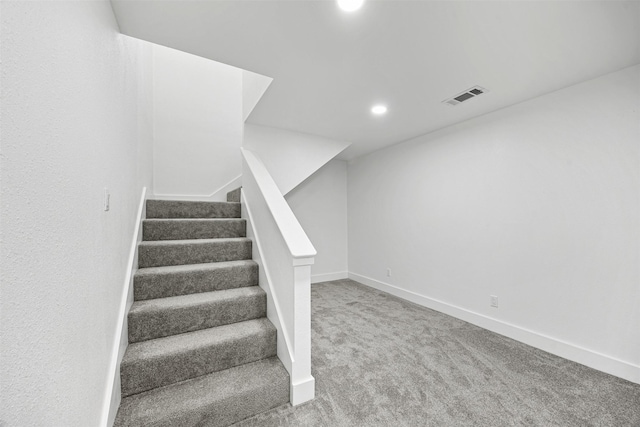 staircase with carpet floors