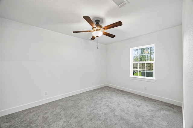 empty room with ceiling fan and carpet flooring