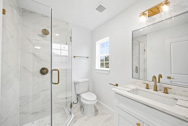 bathroom with toilet, vanity, and walk in shower