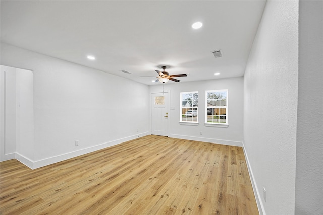 empty room featuring ceiling fan and light hardwood / wood-style floors