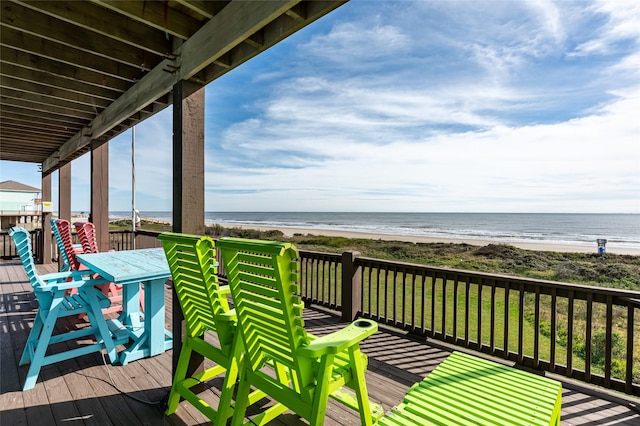 deck featuring a view of the beach and a water view