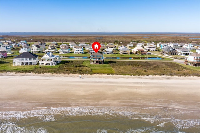 drone / aerial view featuring a beach view and a water view