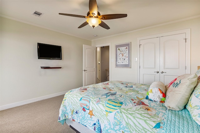 bedroom featuring carpet flooring, ceiling fan, crown molding, and a closet