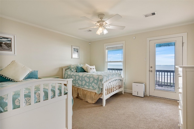 bedroom featuring access to exterior, light carpet, ornamental molding, ceiling fan, and a water view