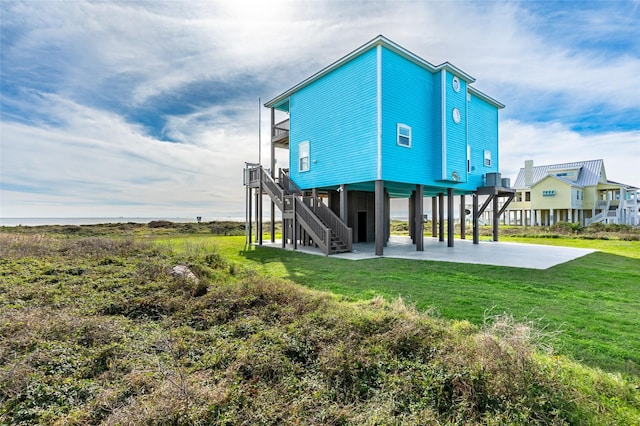 rear view of house featuring a yard