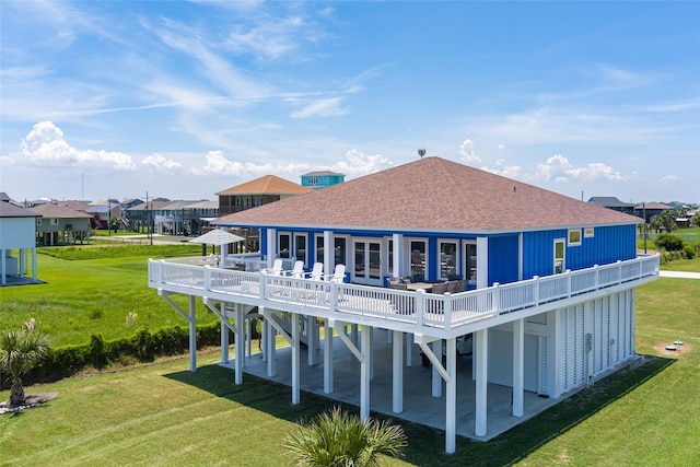 rear view of house with an outdoor hangout area, a lawn, and a wooden deck