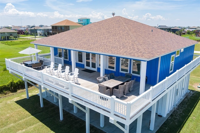 back of house featuring an outdoor living space, a deck, and a yard