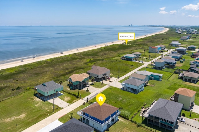 bird's eye view featuring a water view and a beach view