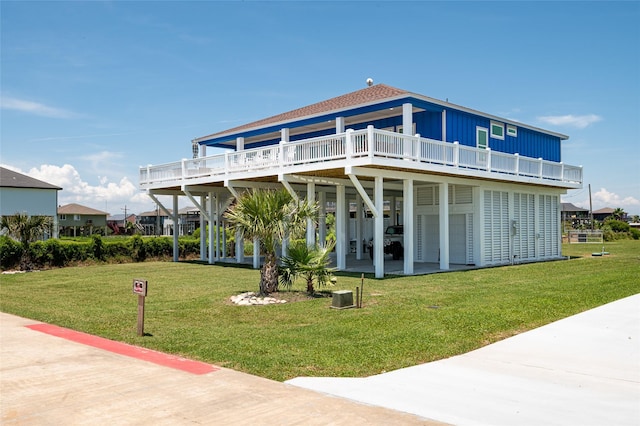 back of house featuring a wooden deck, a yard, and a patio