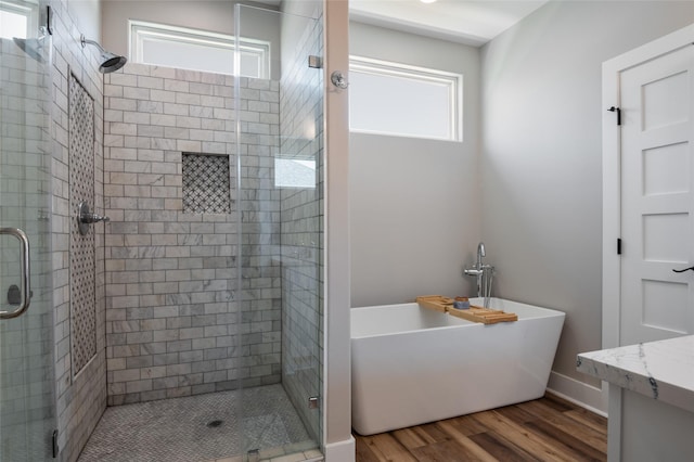 bathroom featuring independent shower and bath, vanity, and wood-type flooring